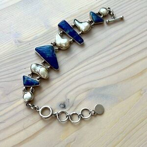 .95 silver pearls and gemstones encased in silver. Bracelet 9 inches long.